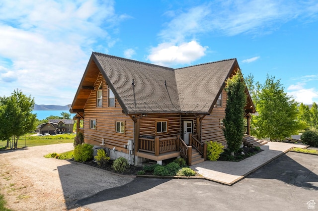125 W Persimmon Dr Unit 2, Garden City, UT 84028 - view of property exterior featuring log siding, a mountain view, and a shingled roof