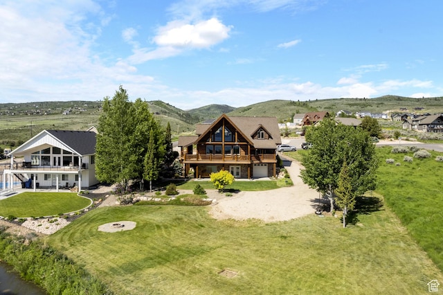 125 W Persimmon Dr Unit 2, Garden City, UT 84028 - back of house featuring a garage, a deck with mountain view, and a yard