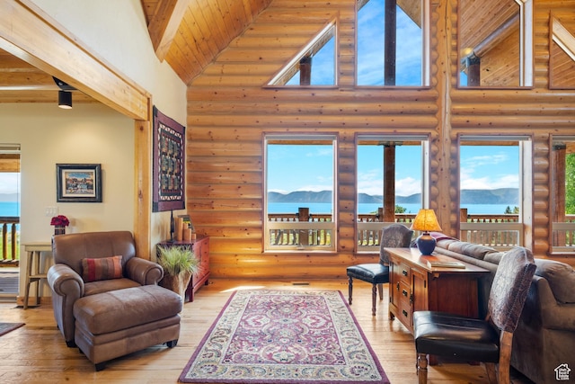 125 W Persimmon Dr Unit 2, Garden City, UT 84028 - living area with rustic walls, high vaulted ceiling, wood ceiling with exposed beams, hardwood / wood-style floors, and a mountain view