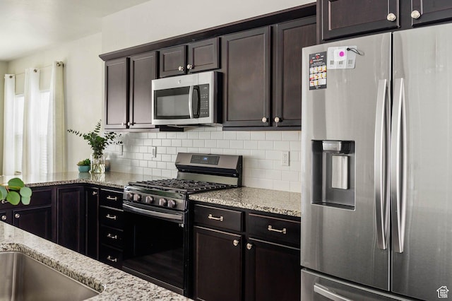 5128 W Stockfield Ln N, Herriman, UT 84096 - kitchen with stainless steel appliances, backsplash, light stone counters, and dark brown cabinets