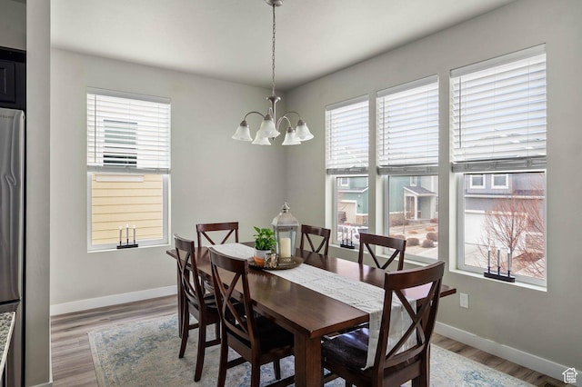 5128 W Stockfield Ln N, Herriman, UT 84096 - dining space featuring a chandelier, light wood-style flooring, and baseboards