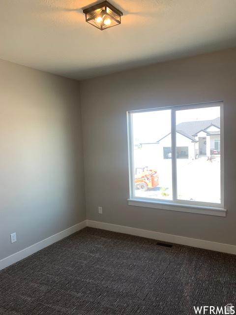 3323 N 1200 W, Pleasant View, UT 84414 - spare room with dark colored carpet and baseboards