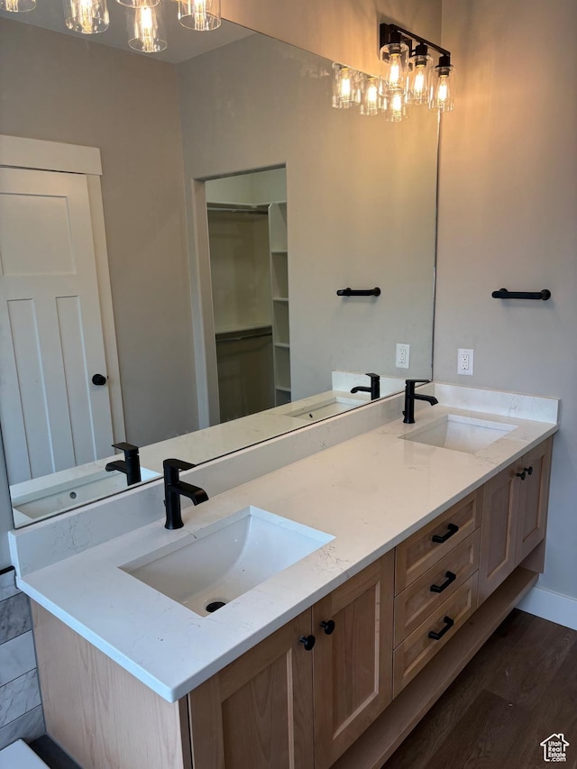 3323 N 1200 W, Pleasant View, UT 84414 - bathroom with double vanity, wood finished floors, and a chandelier