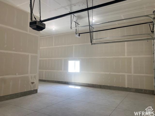3323 N 1200 W, Pleasant View, UT 84414 - garage with a garage door opener and baseboards