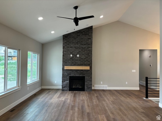 3323 N 1200 W, Pleasant View, UT 84414 - unfurnished living room featuring ceiling fan, wood finished floors, a brick fireplace, high vaulted ceiling, and recessed lighting
