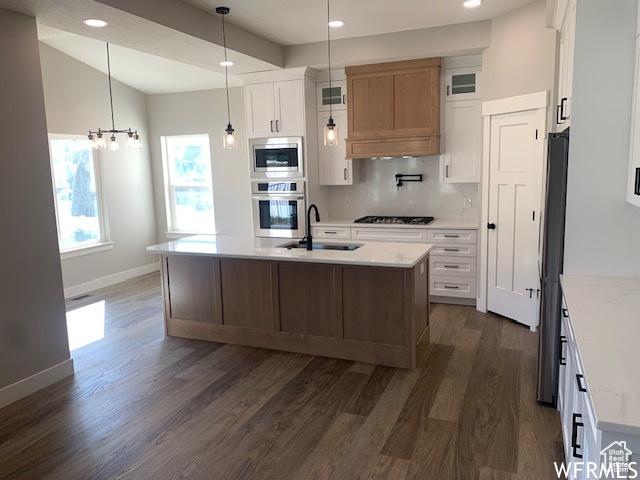 3323 N 1200 W, Pleasant View, UT 84414 - kitchen with appliances with stainless steel finishes, dark wood-type flooring, backsplash, a sink, and baseboards