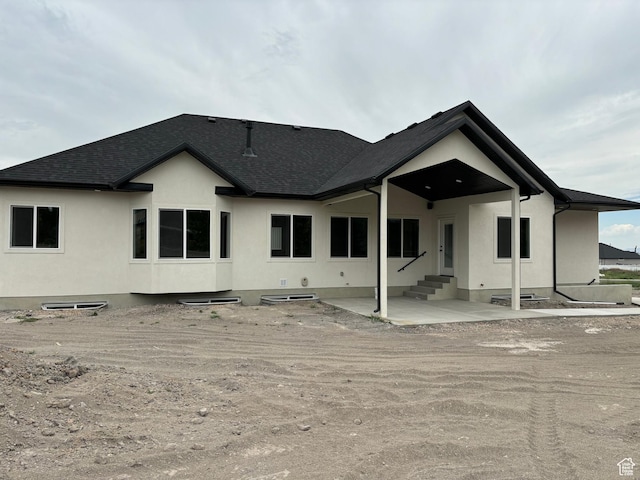 3323 N 1200 W, Pleasant View, UT 84414 - rear view of house featuring roof with shingles, a patio, stucco siding, and entry steps
