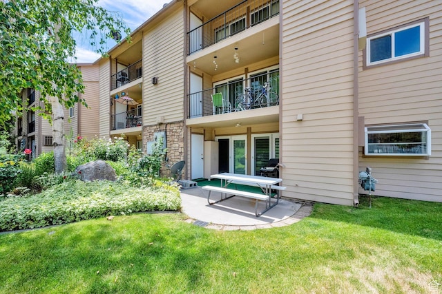 7733 S Briarsprings Dr, Midvale, UT 84047 - rear view of property with a patio and a lawn