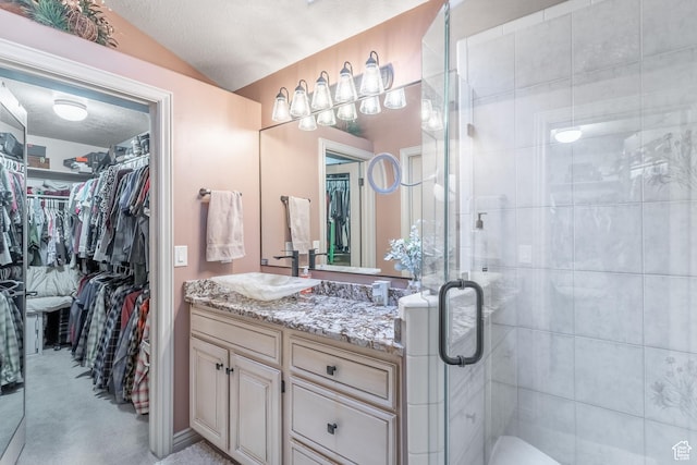 4862 S Kiwana Dr, South Ogden, UT 84403 - full bath featuring vanity, a walk in closet, a shower stall, lofted ceiling, and a textured ceiling