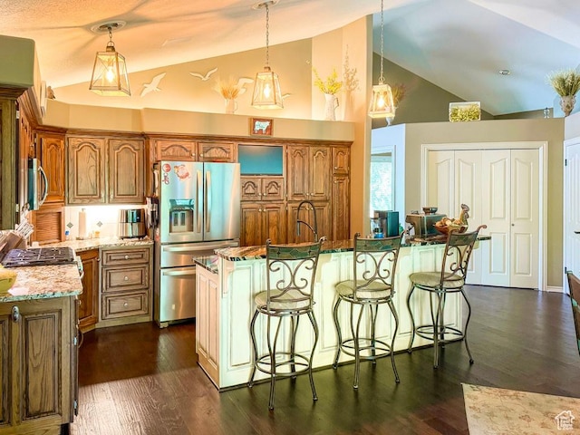4862 S Kiwana Dr, South Ogden, UT 84403 - kitchen with appliances with stainless steel finishes, brown cabinets, a breakfast bar, high vaulted ceiling, and decorative light fixtures