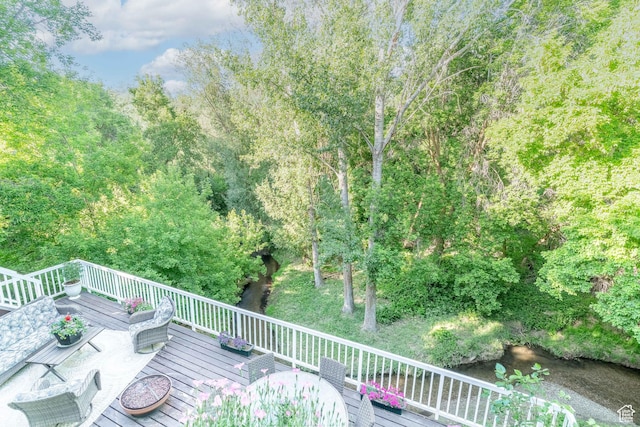 4862 S Kiwana Dr, South Ogden, UT 84403 - wooden terrace with outdoor dining area and a forest view