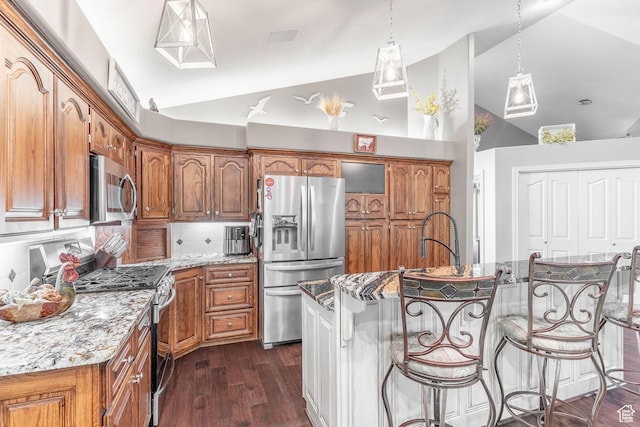 4862 S Kiwana Dr, South Ogden, UT 84403 - kitchen with stainless steel appliances, high vaulted ceiling, brown cabinets, dark wood finished floors, and light stone counters
