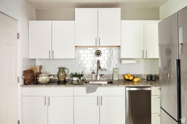 19 S 800 E Unit 3, Salt Lake City, UT 84102 - kitchen with appliances with stainless steel finishes, a sink, white cabinetry, and light stone countertops