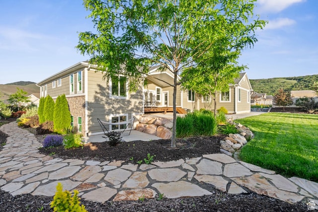588 S 100 E, Mantua, UT 84324 - view of front of house featuring a patio, a front lawn, and a mountain view