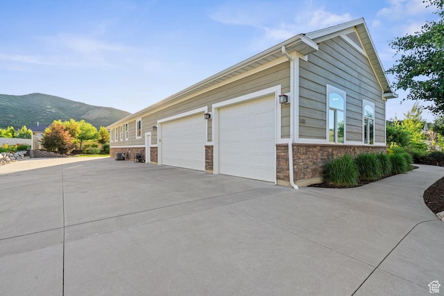 588 S 100 E, Mantua, UT 84324 - view of property exterior with driveway, a mountain view, and stone siding