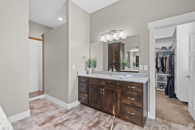 588 S 100 E, Mantua, UT 84324 - full bathroom featuring vanity, a walk in closet, baseboards, and recessed lighting