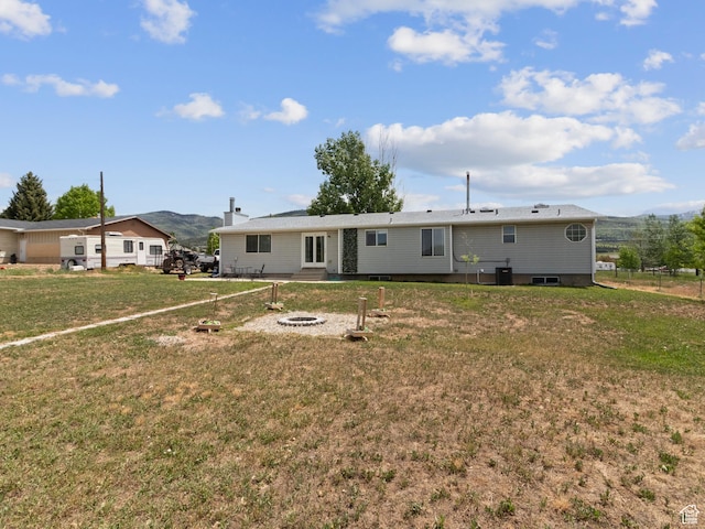 164 S 400 E, Fairview, UT 84629 - rear view of house featuring a yard, a mountain view, and an outdoor fire pit