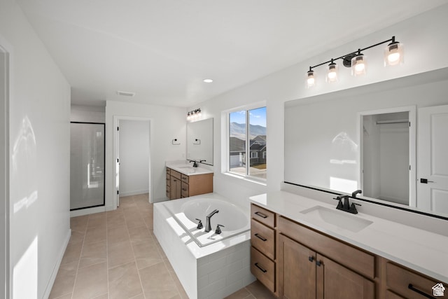 5443 N Cliffrose Dr Unit 637, Eagle Mountain, UT 84005 - full bath with two vanities, a shower stall, a garden tub, tile patterned floors, and baseboards