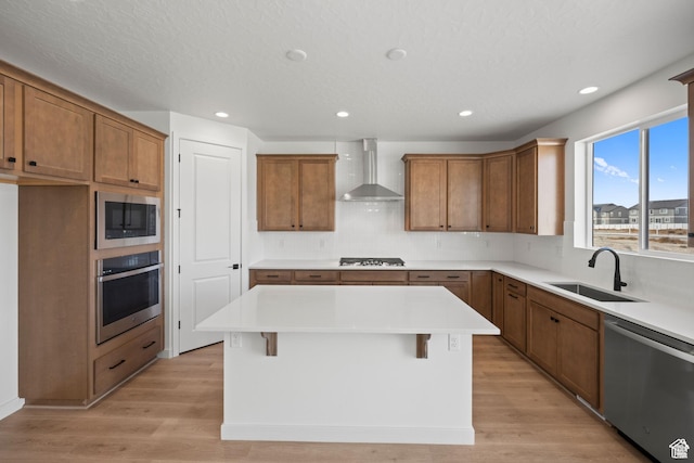 5443 N Cliffrose Dr Unit 637, Eagle Mountain, UT 84005 - kitchen featuring stainless steel appliances, wall chimney exhaust hood, a sink, brown cabinetry, and backsplash