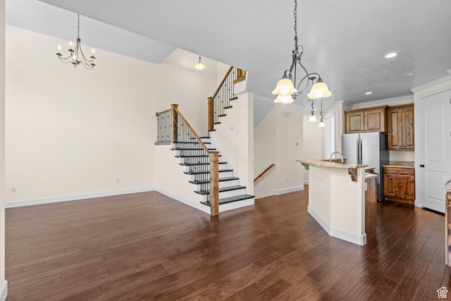923 W 965 N, Orem, UT 84057 - kitchen with a chandelier, brown cabinets, dark wood-style floors, a kitchen bar, and recessed lighting
