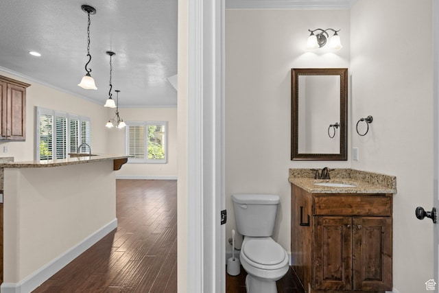 923 W 965 N, Orem, UT 84057 - bathroom featuring vanity, ornamental molding, baseboards, wood finished floors, and toilet
