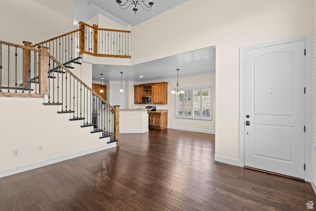 923 W 965 N, Orem, UT 84057 - foyer entrance featuring a chandelier, high vaulted ceiling, dark wood finished floors, stairway, and baseboards