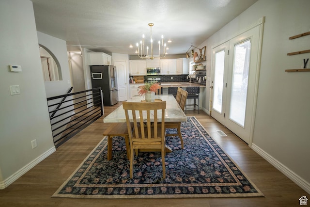 1536 E Mountain Rd, Logan, UT 84321 - dining area with a chandelier, light wood finished floors, and baseboards