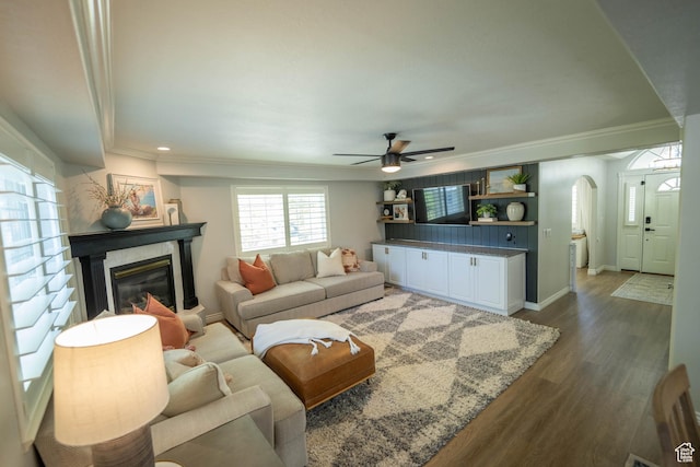 1536 E Mountain Rd, Logan, UT 84321 - living area featuring arched walkways, ceiling fan, dark wood finished floors, crown molding, and baseboards