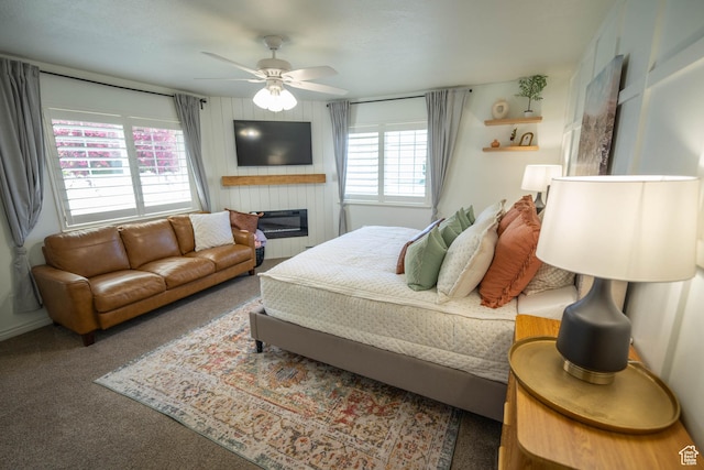 1536 E Mountain Rd, Logan, UT 84321 - bedroom featuring carpet, ceiling fan, and a glass covered fireplace