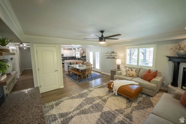 1536 E Mountain Rd, Logan, UT 84321 - living area featuring ceiling fan, ornamental molding, wood finished floors, a tiled fireplace, and a chandelier