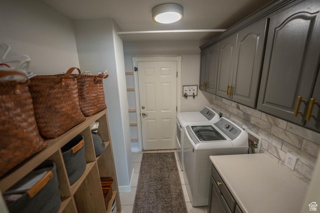 1536 E Mountain Rd, Logan, UT 84321 - laundry area with washing machine and clothes dryer, cabinet space, and light tile patterned flooring