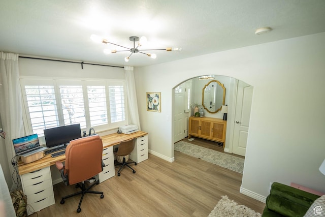 1536 E Mountain Rd, Logan, UT 84321 - home office with a chandelier, light wood-type flooring, arched walkways, and baseboards