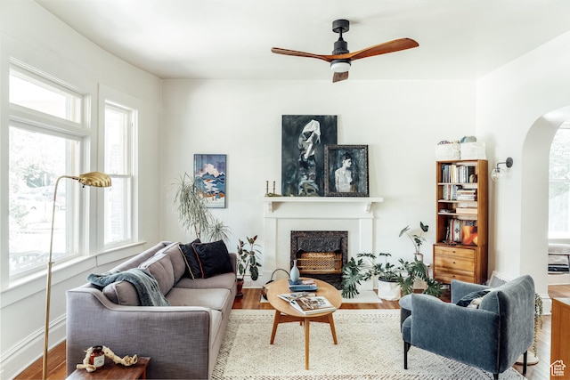 336 S Douglas St S, Salt Lake City, UT 84102 - living area featuring arched walkways, a fireplace with flush hearth, plenty of natural light, and ceiling fan
