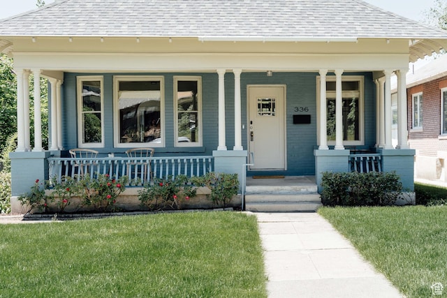 336 S Douglas St S, Salt Lake City, UT 84102 - view of front facade with a shingled roof, covered porch, and a front lawn