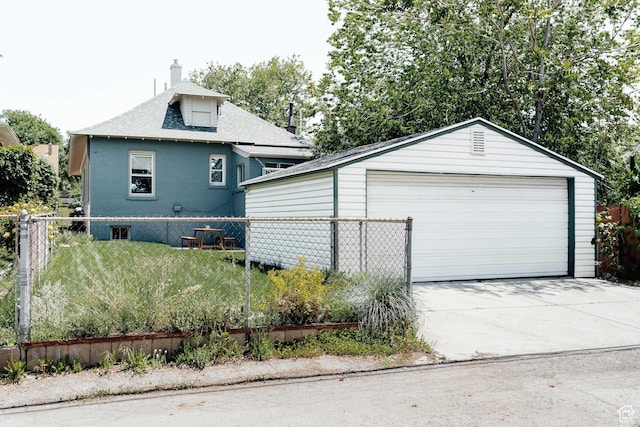 336 S Douglas St S, Salt Lake City, UT 84102 - view of side of property featuring a garage, roof with shingles, an outdoor structure, and a chimney