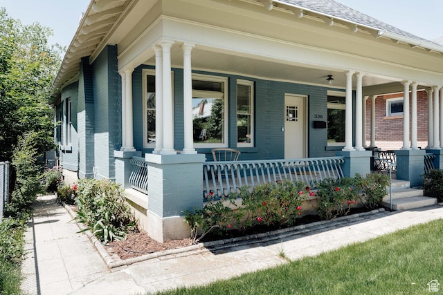 336 S Douglas St S, Salt Lake City, UT 84102 - view of front of property featuring brick siding, covered porch, and a shingled roof