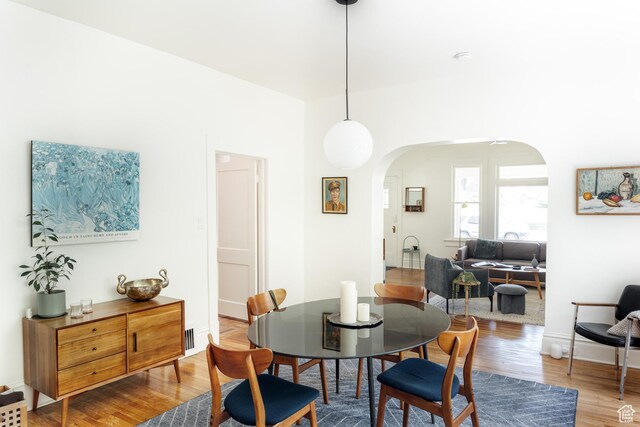 336 S Douglas St S, Salt Lake City, UT 84102 - dining area featuring arched walkways and wood finished floors