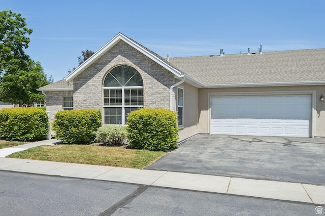 9362 S Abbey View Rd W, West Jordan, UT 84088 - view of front of house featuring driveway, a garage, stucco siding, and a shingled roof
