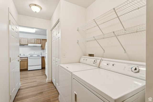 9362 S Abbey View Rd W, West Jordan, UT 84088 - washroom featuring washing machine and clothes dryer, light wood-style flooring, and baseboards