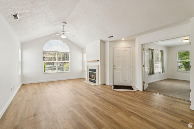 9362 S Abbey View Rd W, West Jordan, UT 84088 - unfurnished living room featuring ceiling fan, light wood finished floors, a fireplace, lofted ceiling, and baseboards