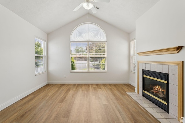 9362 S Abbey View Rd W, West Jordan, UT 84088 - unfurnished living room with light wood-type flooring, a fireplace, a ceiling fan, lofted ceiling, and baseboards