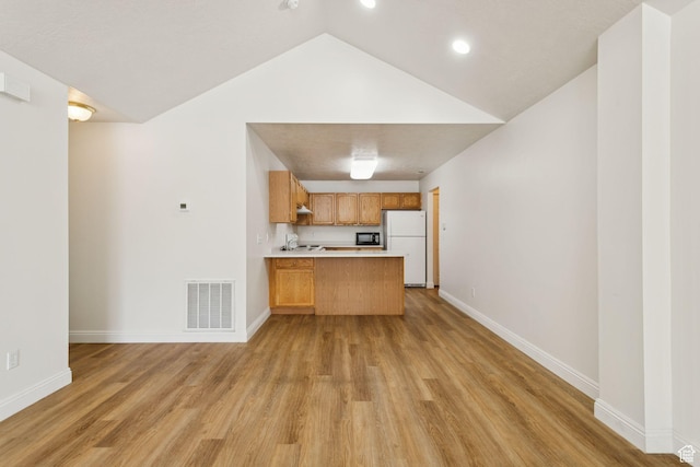 9362 S Abbey View Rd W, West Jordan, UT 84088 - kitchen with freestanding refrigerator, a peninsula, open floor plan, light countertops, and light wood finished floors