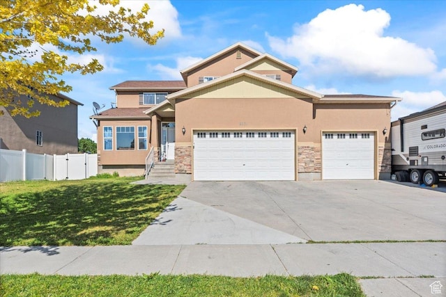 6731 S Ticklegrass Rd W, West Jordan, UT 84081 - view of front of house featuring stucco siding, stone siding, concrete driveway, and a garage