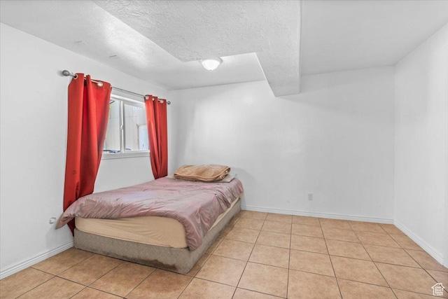 6731 S Ticklegrass Rd W, West Jordan, UT 84081 - bedroom with light tile patterned floors, baseboards, and a textured ceiling