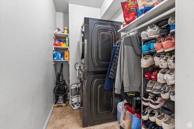6731 S Ticklegrass Rd W, West Jordan, UT 84081 - laundry area featuring stacked washing machine and dryer and baseboards