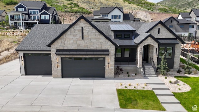 4893 W Ridge Rock Cir, Herriman, UT 84096 - view of front of house featuring stone siding, concrete driveway, an attached garage, a mountain view, and covered porch
