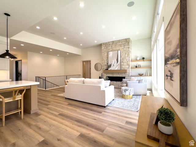 4893 W Ridge Rock Cir, Herriman, UT 84096 - living room with light wood finished floors, a fireplace, and recessed lighting
