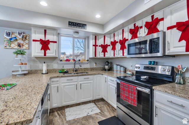 685 E Bullrush Pkwy E, Lehi, UT 84043 - kitchen with appliances with stainless steel finishes, a sink, white cabinetry, recessed lighting, and light stone counters