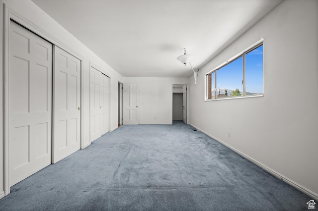 2220 E Murray Holladay Rd Unit 184, Holladay, UT 84117 - unfurnished bedroom featuring carpet flooring, multiple closets, and baseboards