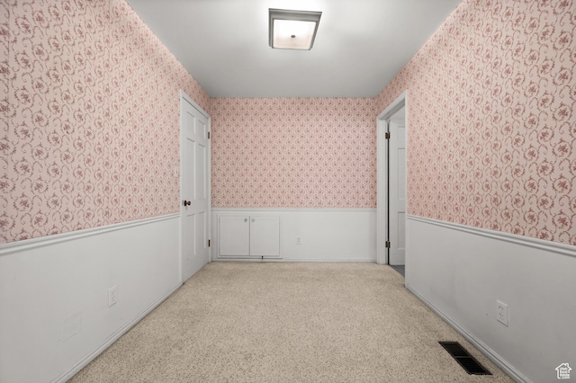 2220 E Murray Holladay Rd Unit 184, Holladay, UT 84117 - carpeted spare room featuring wallpapered walls and a wainscoted wall